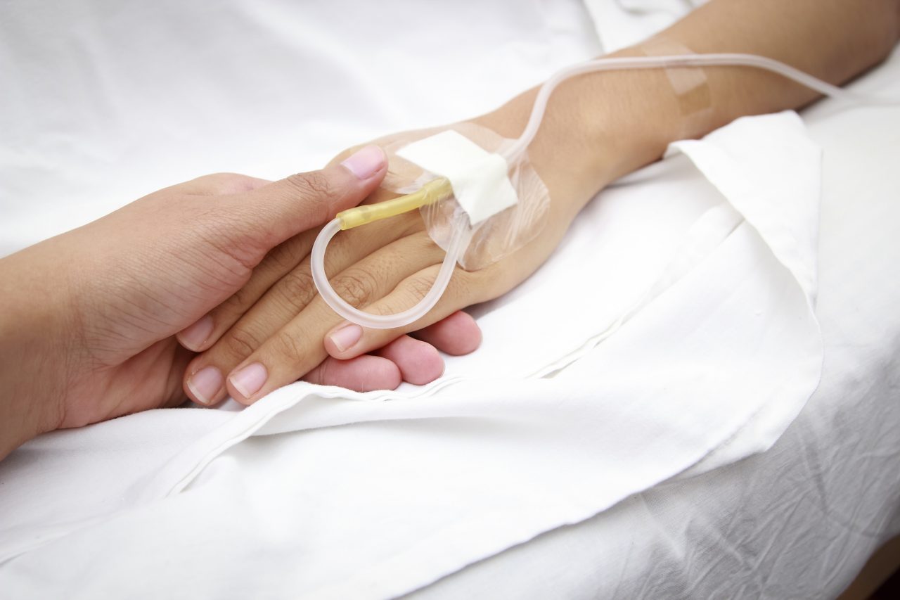 Patient in Hospital with Saline Intravenous Medical Tube
